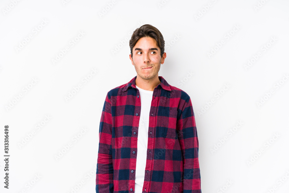 Young caucasian man posing in a pink background isolated confused, feels doubtful and unsure. Young caucasian man posing in a pink background isolated confused, feels doubtful and unsure.