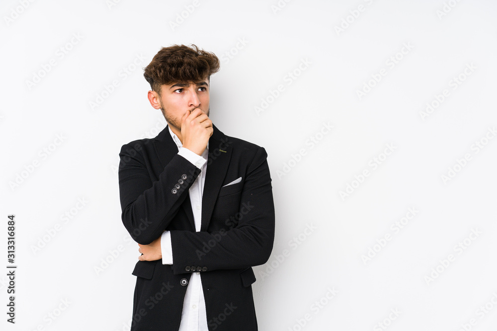 Young arabian business man isolated thoughtful looking to a copy space covering mouth with hand. Young arabian business man isolated thoughtful looking to a copy space covering mouth with hand.