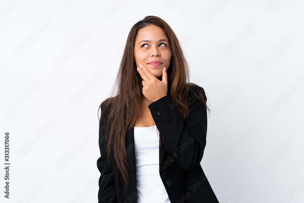 Young Brazilian girl with blazer over isolated white background thinking an idea Young Brazilian girl with blazer over isolated white background thinking an idea