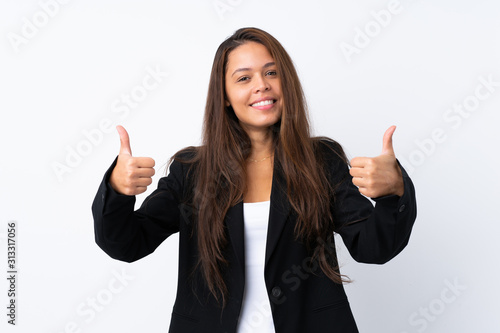 Young Brazilian girl with blazer over isolated white background giving a thumbs up gesture