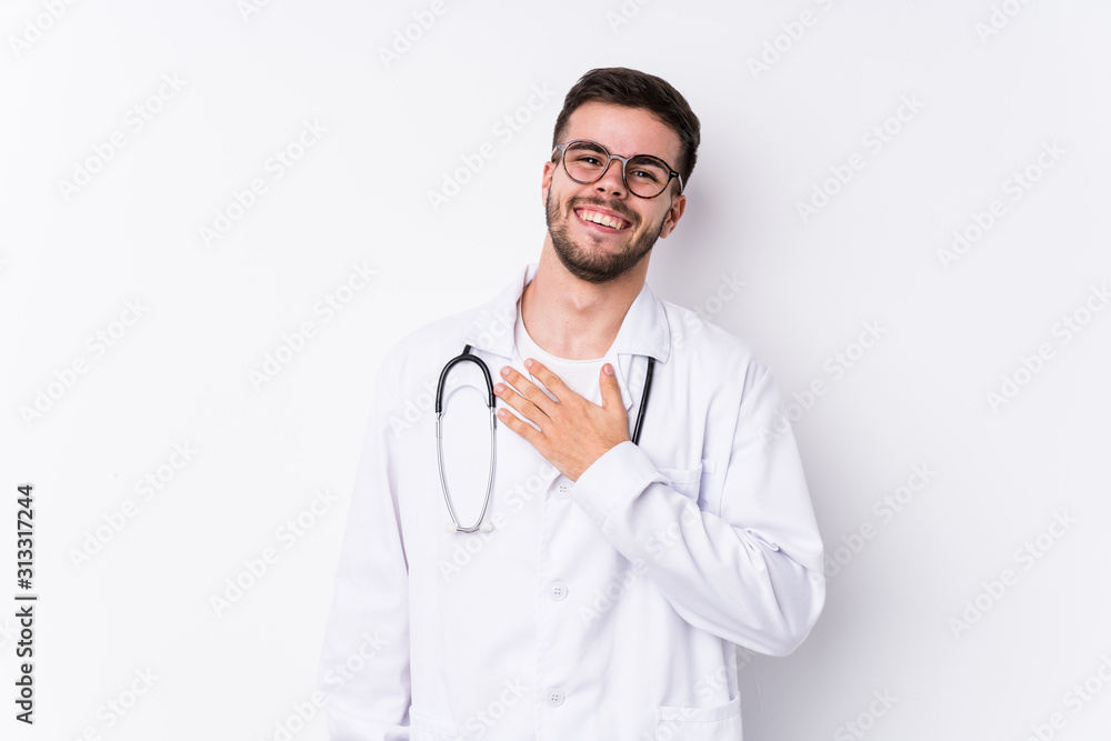 Young caucasian doctor man isolated laughs out loudly keeping hand on chest. Young caucasian doctor man isolated laughs out loudly keeping hand on chest.