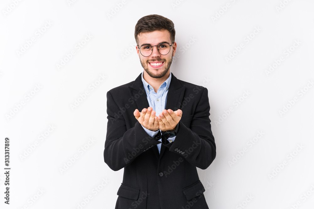 Young caucasian business man posing in a white background isolated Young caucasian business man holding something with palms, offering to camera. Young caucasian business man posing in a white background isolated Young caucasian business man holding something with palms, offering to camera.