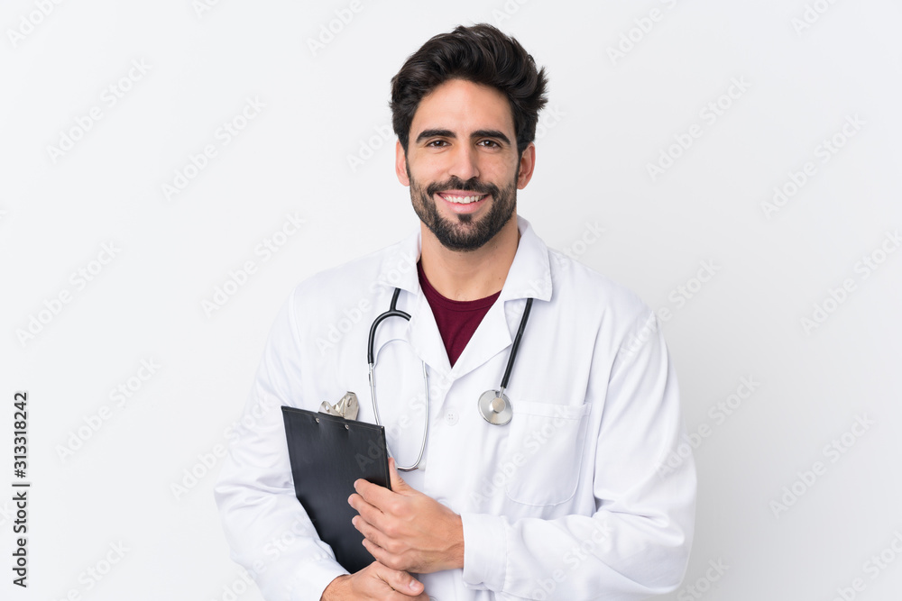 Young handsome man with beard over isolated white background wearing a doctor gown and holding a folder Young handsome man with beard over isolated white background wearing a doctor gown and holding a folder
