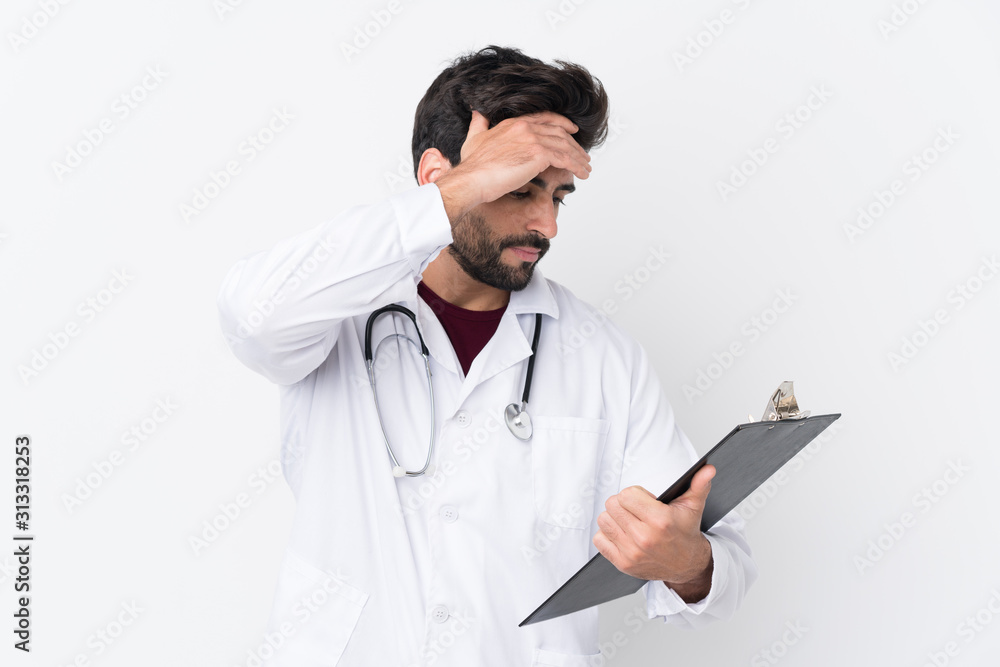 Young handsome man with beard over isolated white background wearing a doctor gown and holding a folder Young handsome man with beard over isolated white background wearing a doctor gown and holding a folder
