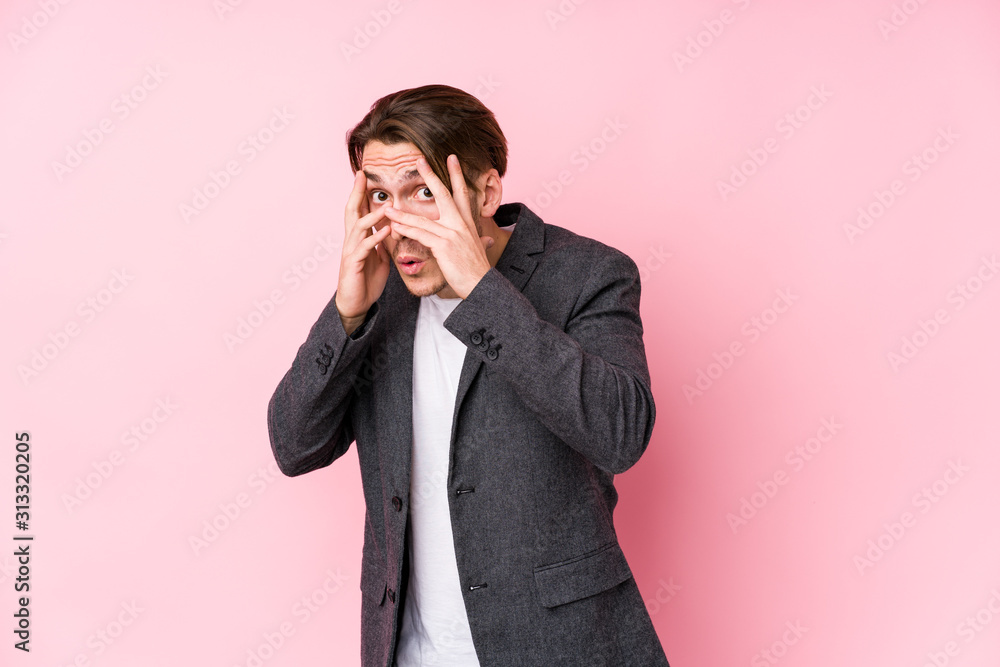 Young caucasian business man posing isolated blink through fingers frightened and nervous. Young caucasian business man posing isolated blink through fingers frightened and nervous.
