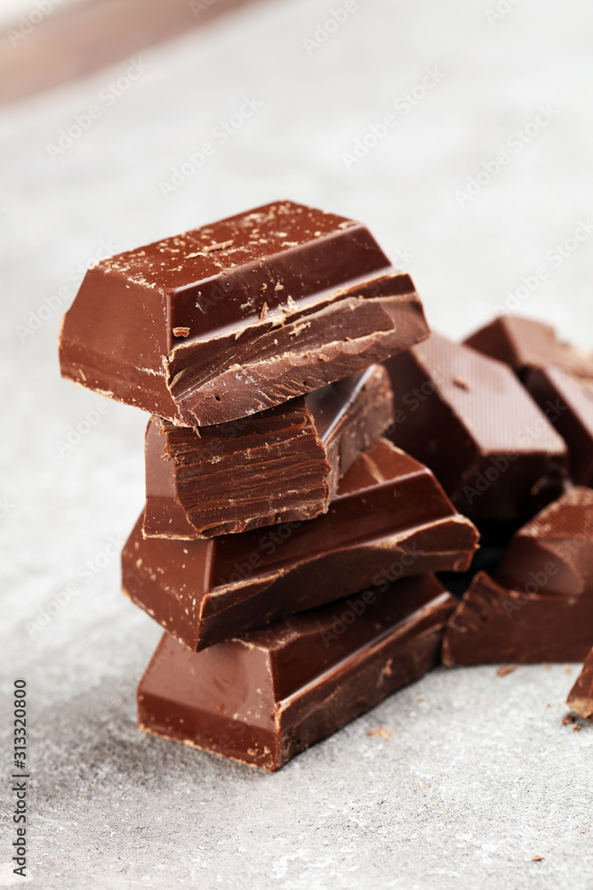 Dark chocolate stack, chips and powder with chocolate bars and block Dark chocolate stack, chips and powder with chocolate bars and block