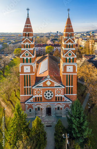 Budapest, Hungary - Aerial drone view of the Saint Michael's Parish Church on an autumn morning with clear blue sky photo