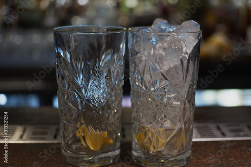 Two glasses one with ice