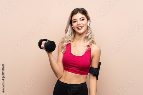 Teenager sport girl over isolated background making weightlifting