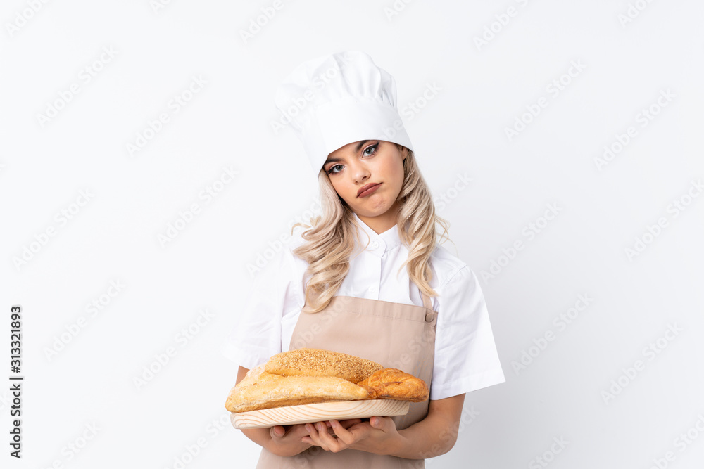 Teenager girl in chef uniform. Female baker holding a table with several breads over isolated white background thinking an idea Teenager girl in chef uniform. Female baker holding a table with several breads over isolated white background thinking an idea