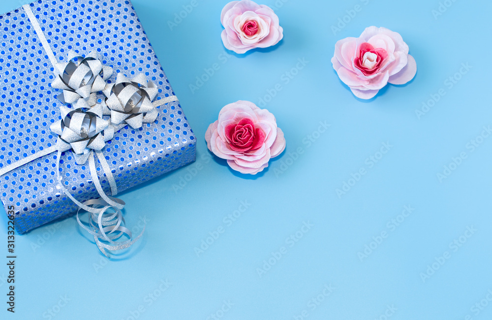 Gift box Packed in blue paper on a blue background . Gift box Packed in blue paper on a blue background .