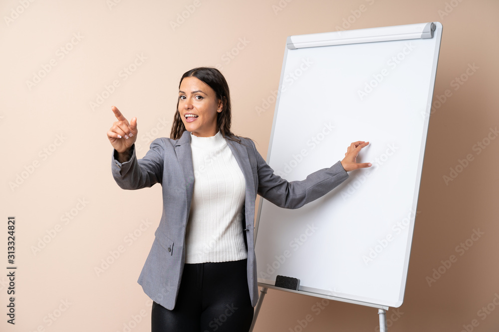 Young woman giving a presentation on white board giving a presentation on white board Young woman giving a presentation on white board giving a presentation on white board