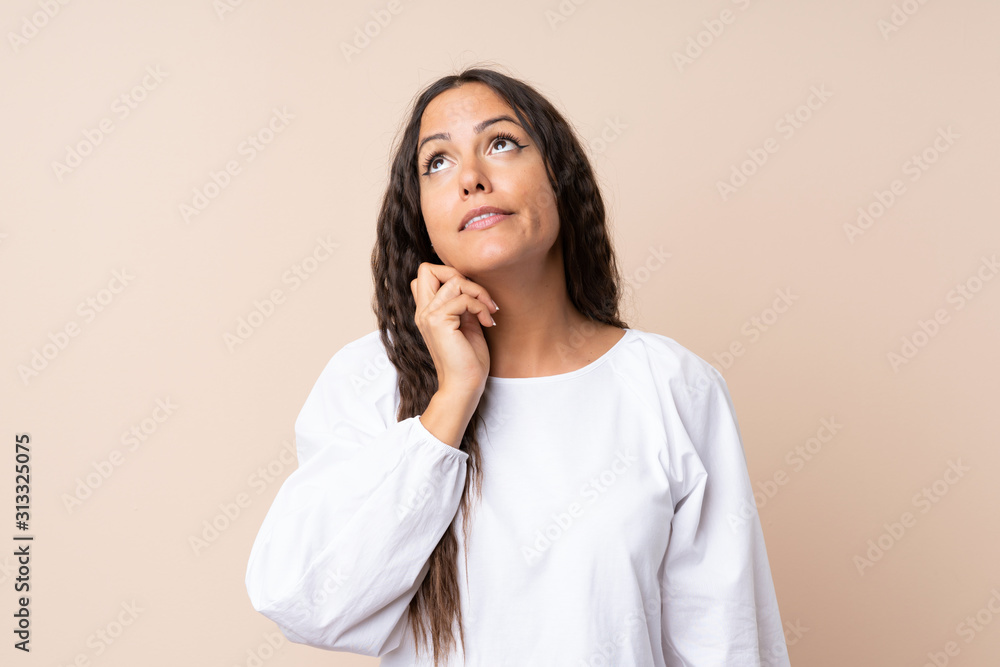 Young woman over isolated background thinking an idea Young woman over isolated background thinking an idea