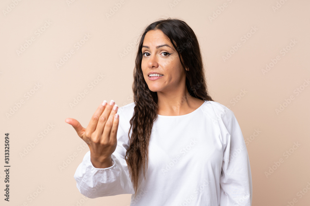 Young woman over isolated background inviting to come Young woman over isolated background inviting to come