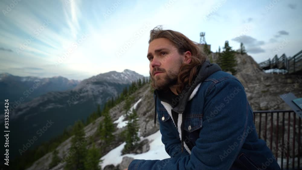 Smiling young man looking out over Jasper National, Alberta, Canada Smiling young man looking out over Jasper National, Alberta, Canada