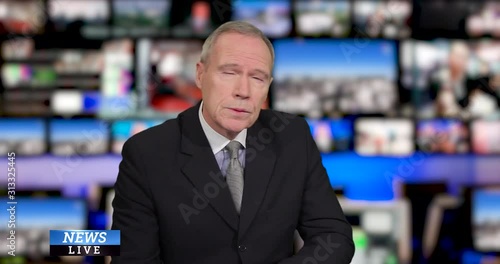 MS senior male anchor speaking at news desk in television studio