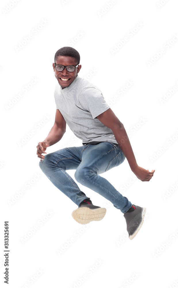cheerful guy in glasses jumping high up . isolated on white cheerful guy in glasses jumping high up . isolated on white