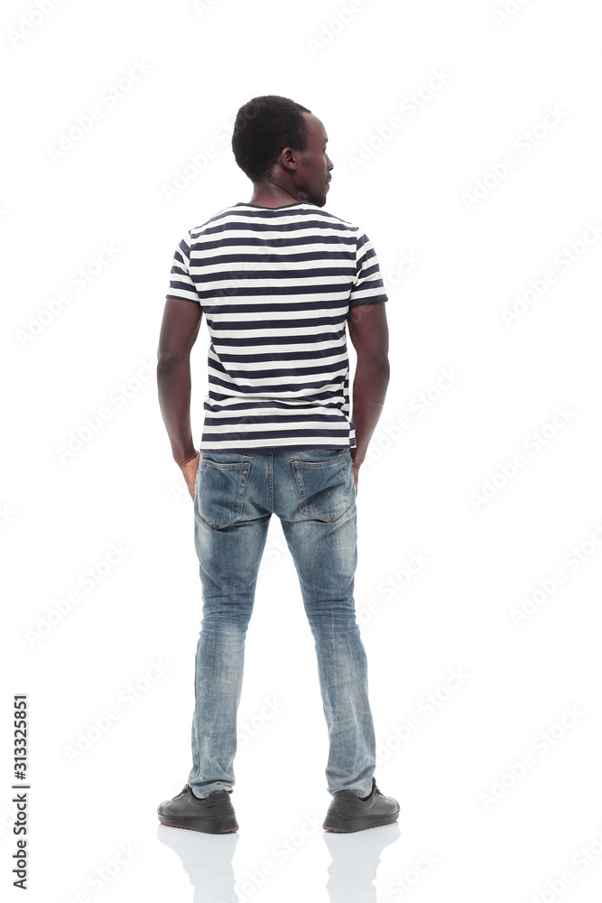 rear view. a young man reading something on a white wall