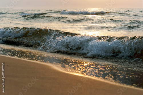 Fototapeta Naklejka Na Ścianę i Meble -  Sunset over the sea. Reflection of sunlight in the sea waves. The sky in the sunset rays.