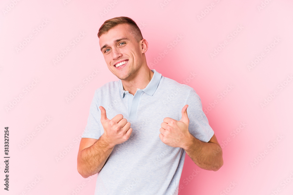 Young caucasian man isolated raising both thumbs up, smiling and confident. Young caucasian man isolated raising both thumbs up, smiling and confident.