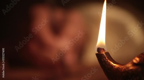 Traditional oil lamp in oriental style showing a write in background photo