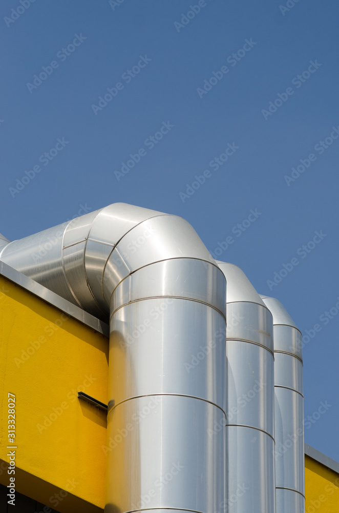 curved pipes, distribution pipes or utility lines on a building. The pipes of the service system on the roof are covered with a galvanized steel cover. curved pipes, distribution pipes or utility lines on a building. The pipes of the service system on the roof are covered with a galvanized steel cover.