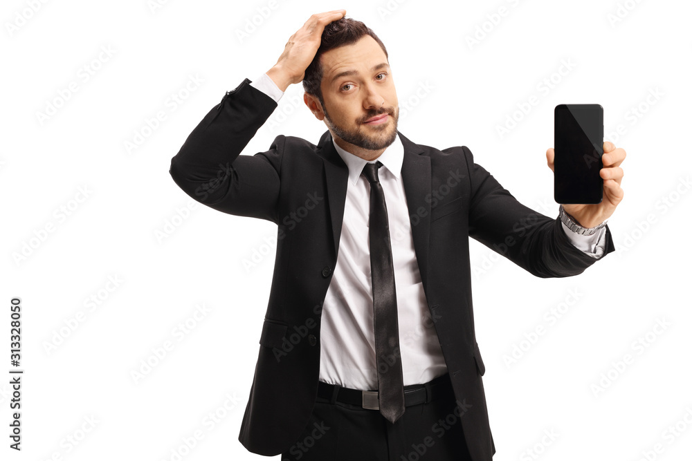 Unhappy businessman holding his head and showing a mobile phone Unhappy businessman holding his head and showing a mobile phone