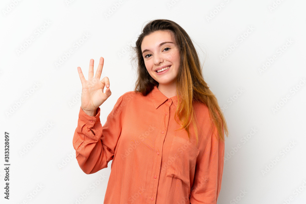 Young brunette girl over isolated white background showing ok sign with fingers Young brunette girl over isolated white background showing ok sign with fingers
