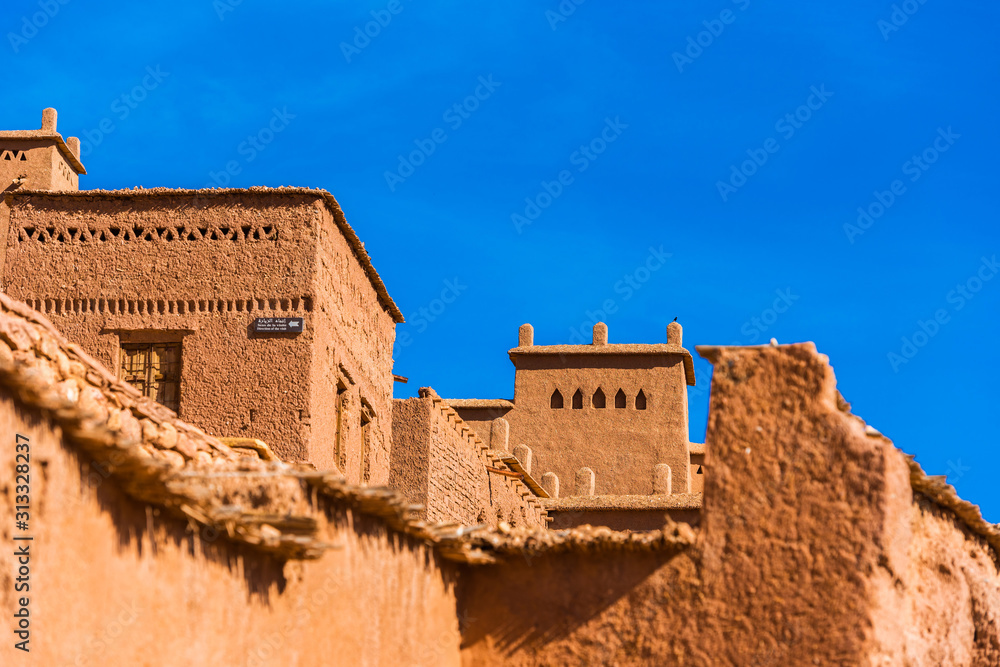 View of the facade of a building in Ait-Ben-Haddou, Morocco. Isolated on blue background.