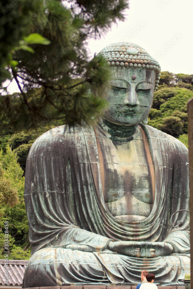 Kamakura, Japan - July 27, 2019: Monumental bronze statue of the Great Buddha in Kamakura Kamakura, Japan - July 27, 2019: Monumental bronze statue of the Great Buddha in Kamakura