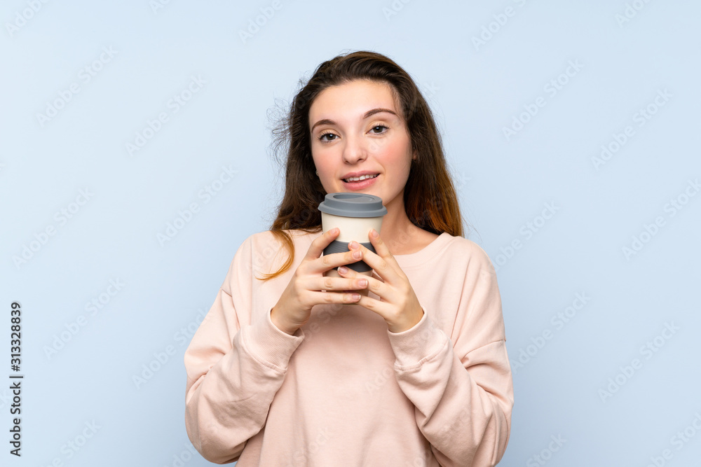 Young brunette girl over isolated blue background holding coffee to take away Young brunette girl over isolated blue background holding coffee to take away