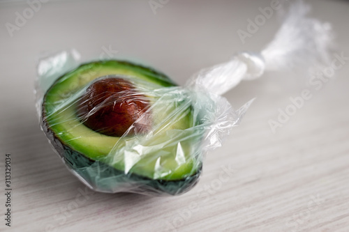 Half of avocado packed in a plastic bag