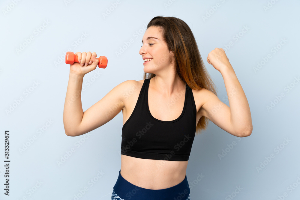 Young sport woman with weightlifting over isolated blue background celebrating a victory Young sport woman with weightlifting over isolated blue background celebrating a victory