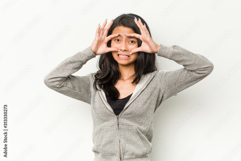 Young fitness chinese woman keeping eyes opened to find a success opportunity. Young fitness chinese woman keeping eyes opened to find a success opportunity.