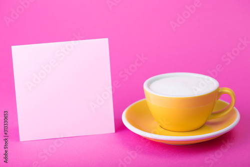 yellow cup on a pink  background