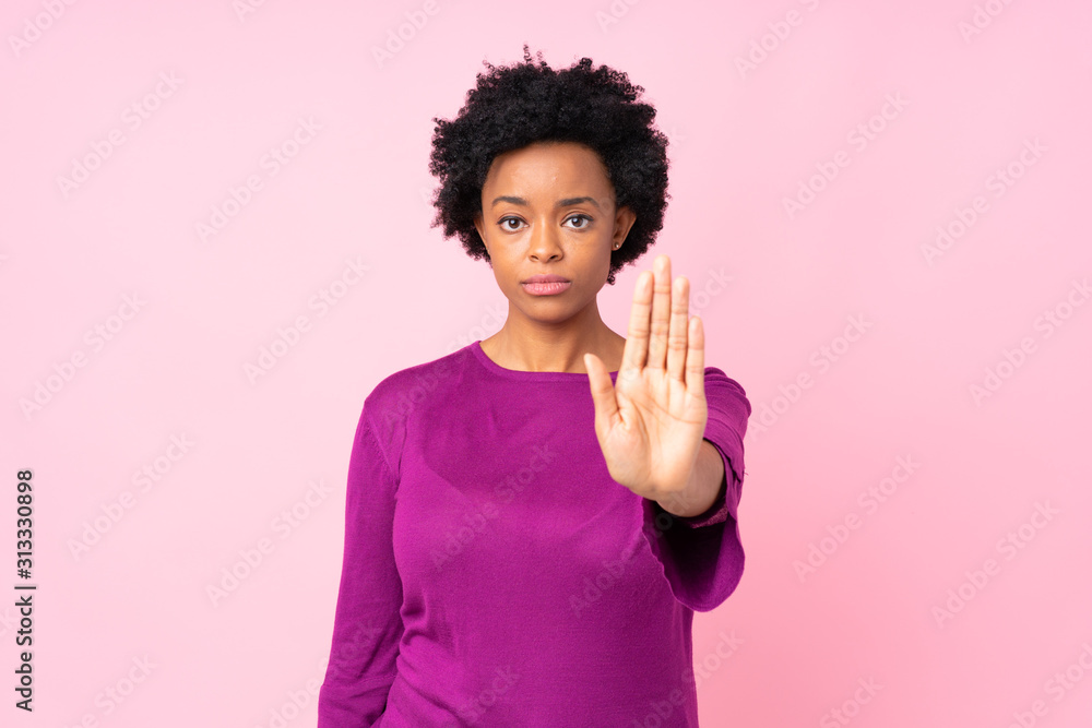 African american woman over isolated pink background making stop gesture African american woman over isolated pink background making stop gesture