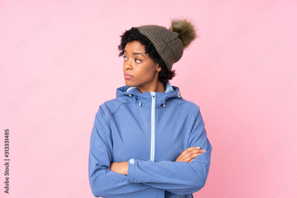 African american woman with winter hat over isolated pink background looking side African american woman with winter hat over isolated pink background looking side