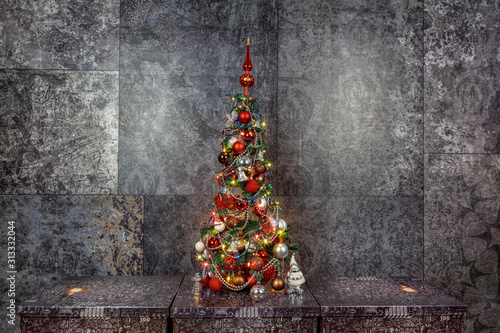 Obraz na płótnie Decorated Christmas tree on a dark base, with a dark background. w salonie