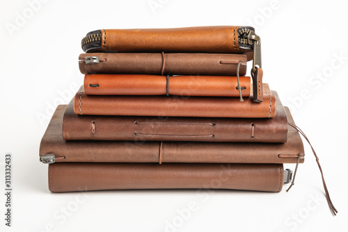 A Stack Of Leather-Bound Journals, Notebooks, Wallets & Cases