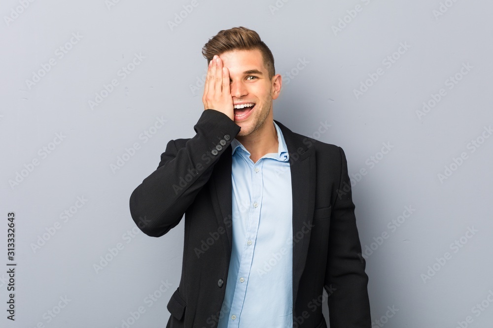 Young handsome caucasian man having fun covering half of face with palm. Young handsome caucasian man having fun covering half of face with palm.