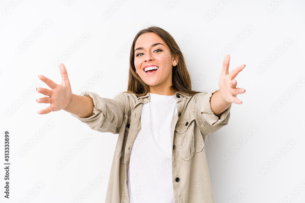 Young caucasian woman isolated feels confident giving a hug to the camera. Young caucasian woman isolated feels confident giving a hug to the camera.