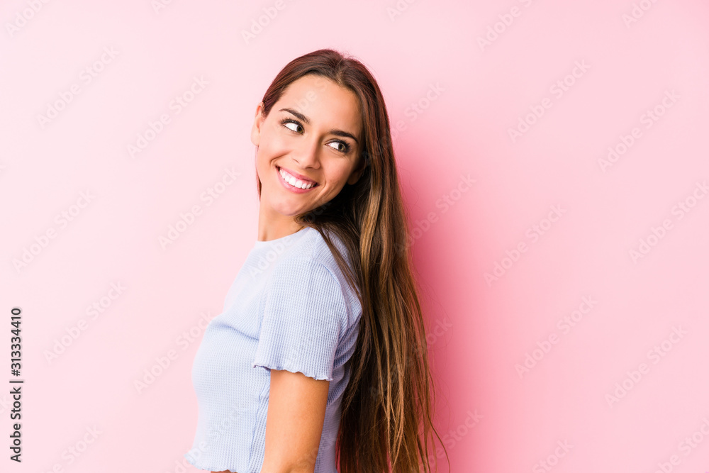 Young caucasian woman wearing a ski clothes isolated looks aside smiling, cheerful and pleasant. Young caucasian woman wearing a ski clothes isolated looks aside smiling, cheerful and pleasant.