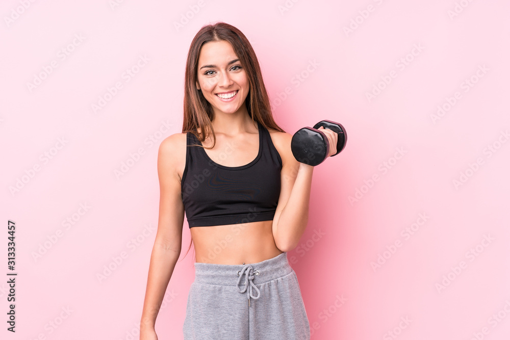 Young caucasian sporty woman holding a dumbbell Young caucasian sporty woman holding a dumbbell