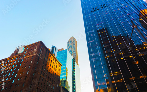 Wallpaper Mural Bottom up Street view on Financial District of Lower Manhattan, New York City, NYC, USA. Skyscrapers tall glass buildings United States of America. Blue sky on background. Empty place for copy space. Torontodigital.ca