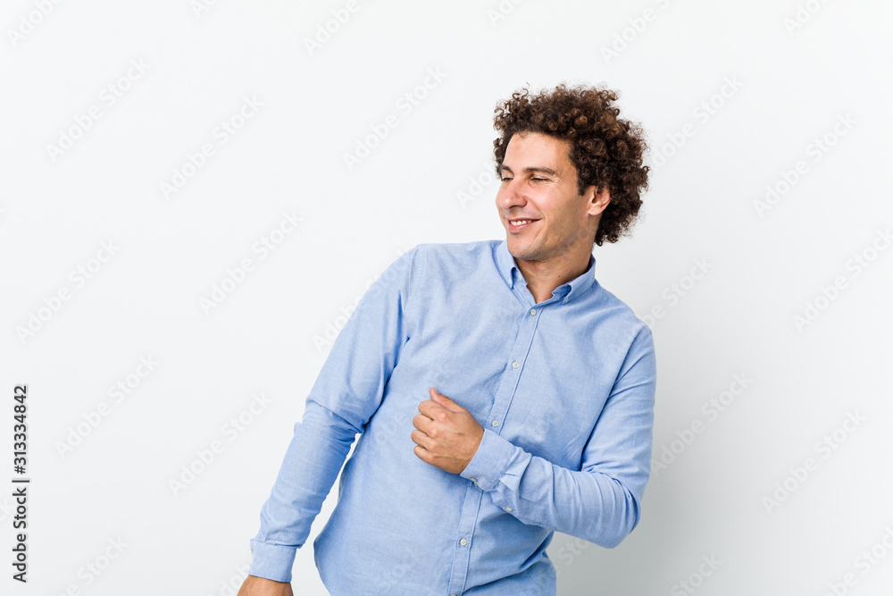 Young curly mature man wearing an elegant shirt dancing and having fun. Young curly mature man wearing an elegant shirt dancing and having fun.
