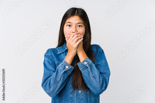 Young asian woman shocked covering mouth with hands.