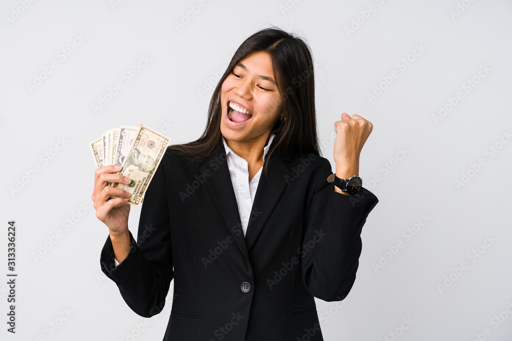Young chinese business woman holding money isolated Young chinese business woman holding money isolated
