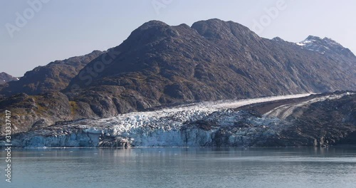 Glacier Bay Alaska cruise vacation travel. Global warming and climate change concept with melting ice. Nature landscape of Lamplugh Glacier and Mount Fairweather Range mountains. photo