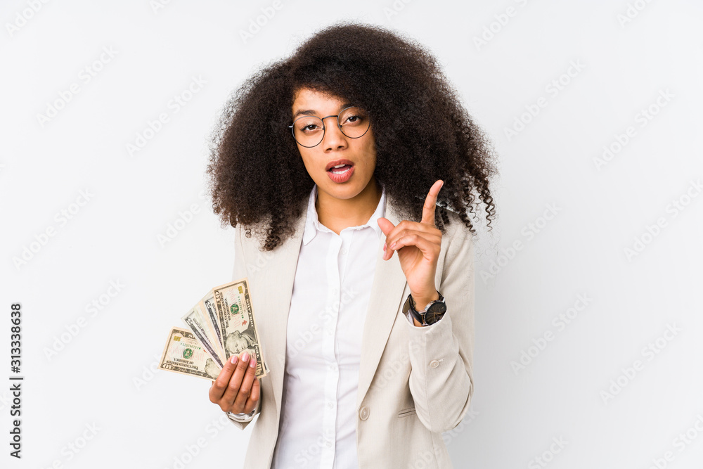 Young afro business woman holding a credit car isolated Young afro business woman holding a credit carhaving an idea, inspiration concept. Young afro business woman holding a credit car isolated Young afro business woman holding a credit carhaving an idea, inspiration concept.