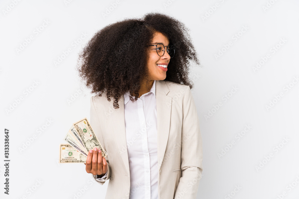 Young afro business woman holding a credit car isolated Young afro business woman holding a credit carlooks aside smiling, cheerful and pleasant. Young afro business woman holding a credit car isolated Young afro business woman holding a credit carlooks aside smiling, cheerful and pleasant.